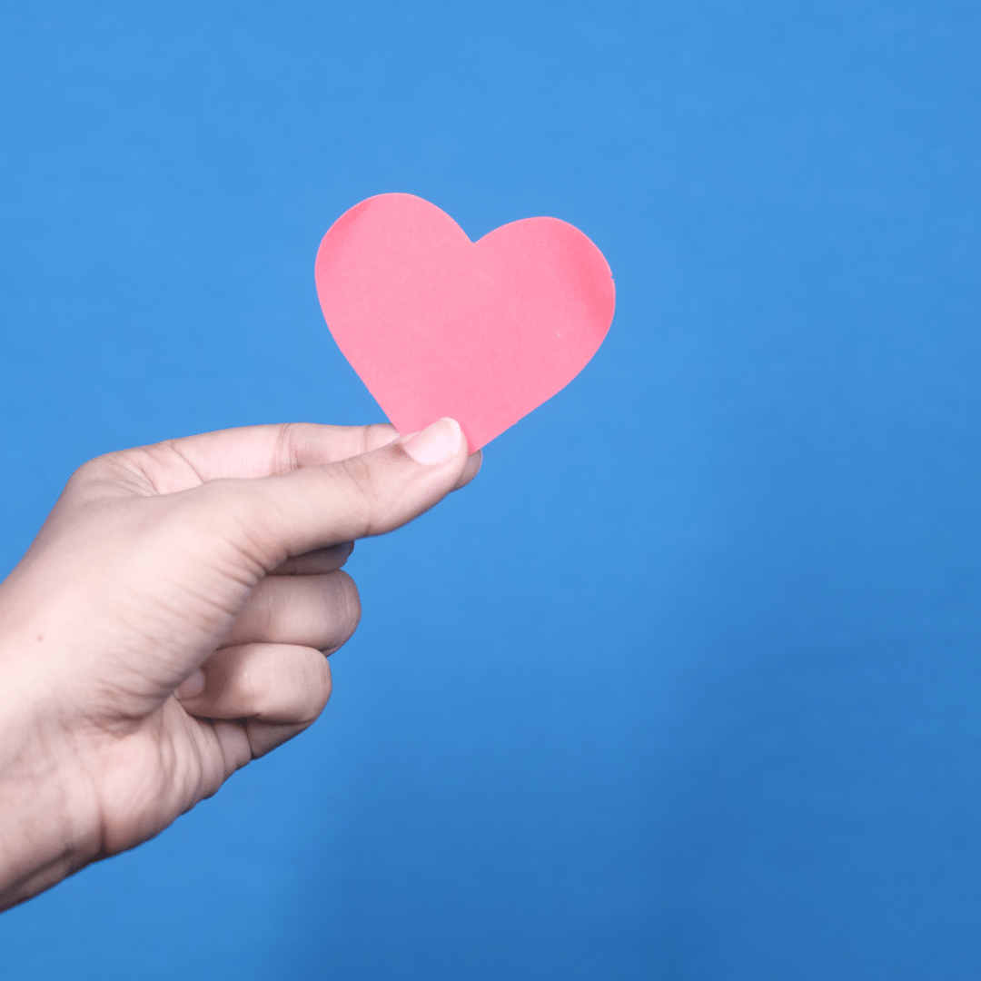 hand holding paper heart